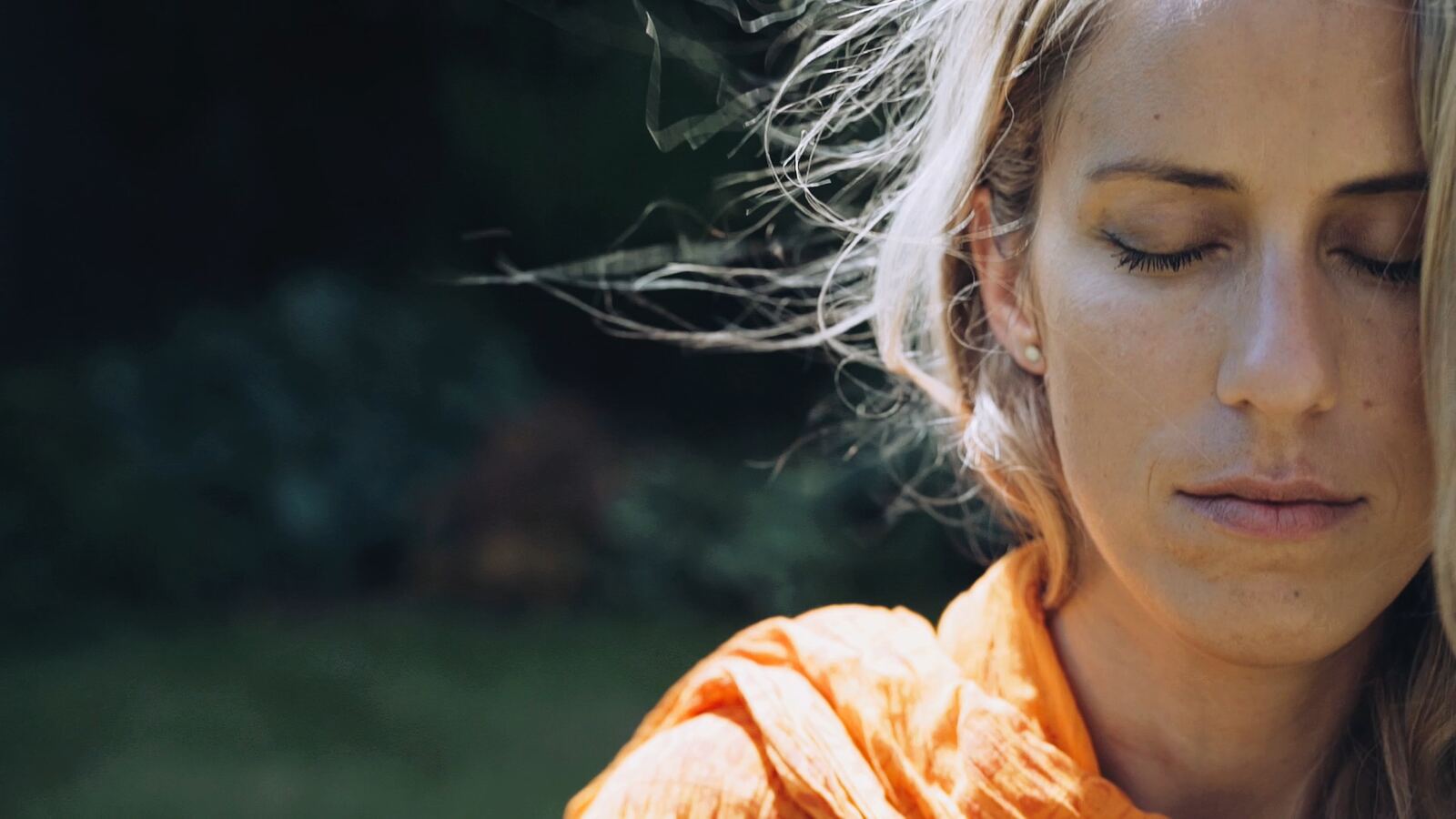Magdalena with eyes closed, hair moving in the wind
